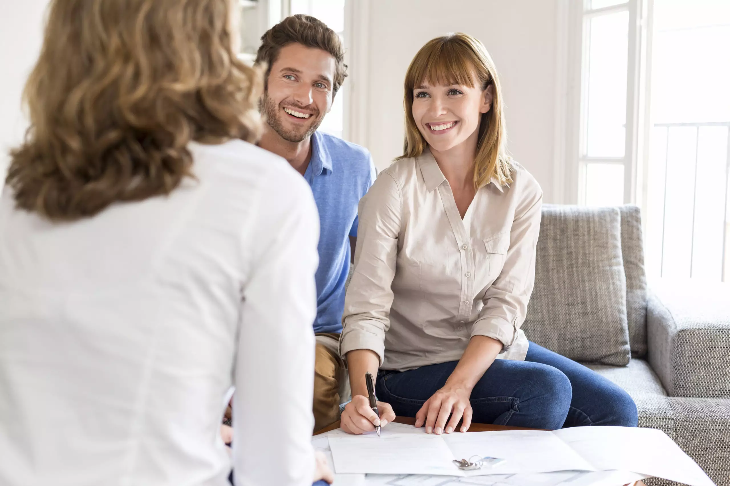 Young couple owners meeting real estate agent for house investme